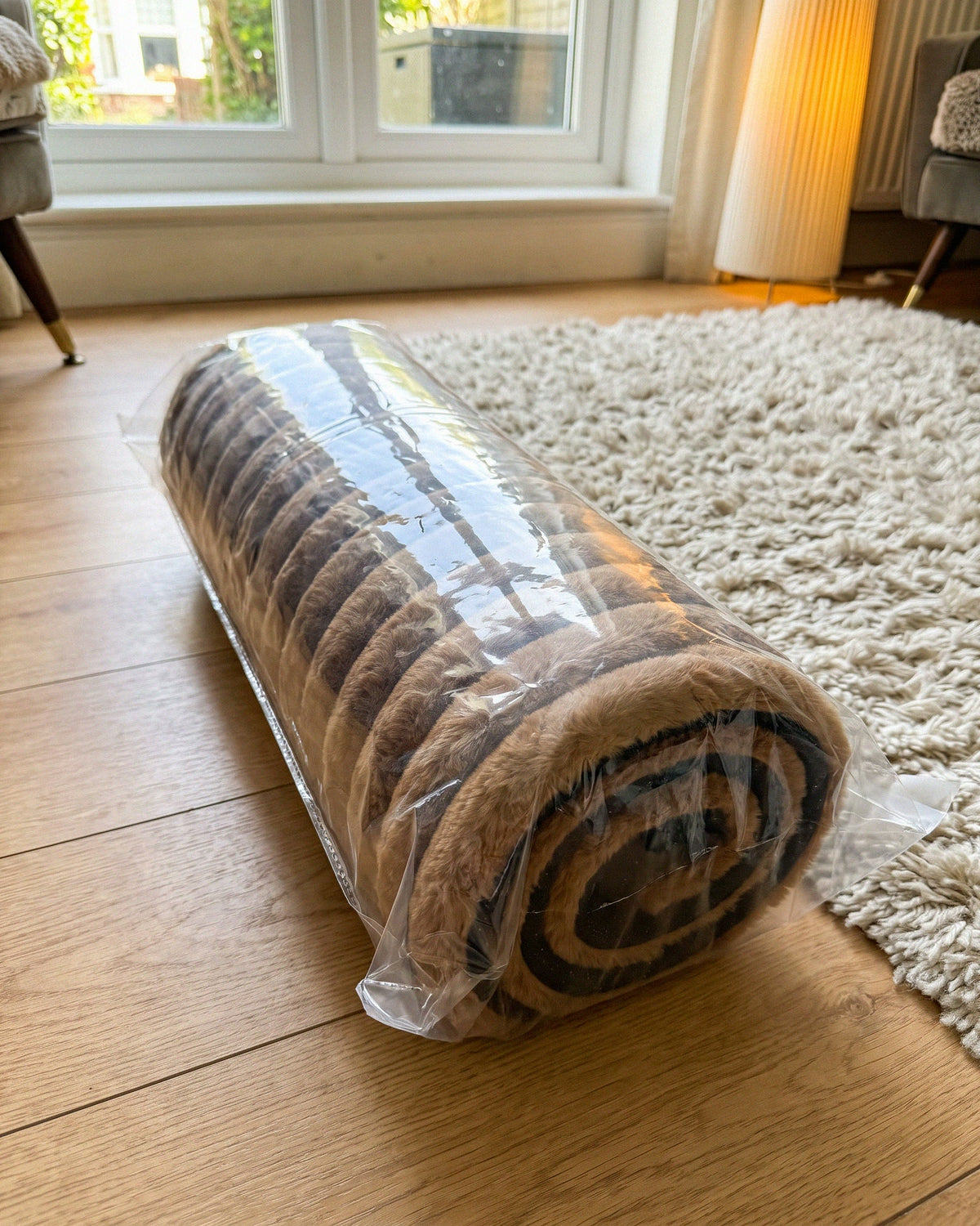 The mat rolled up in its clear bag, as it arrives